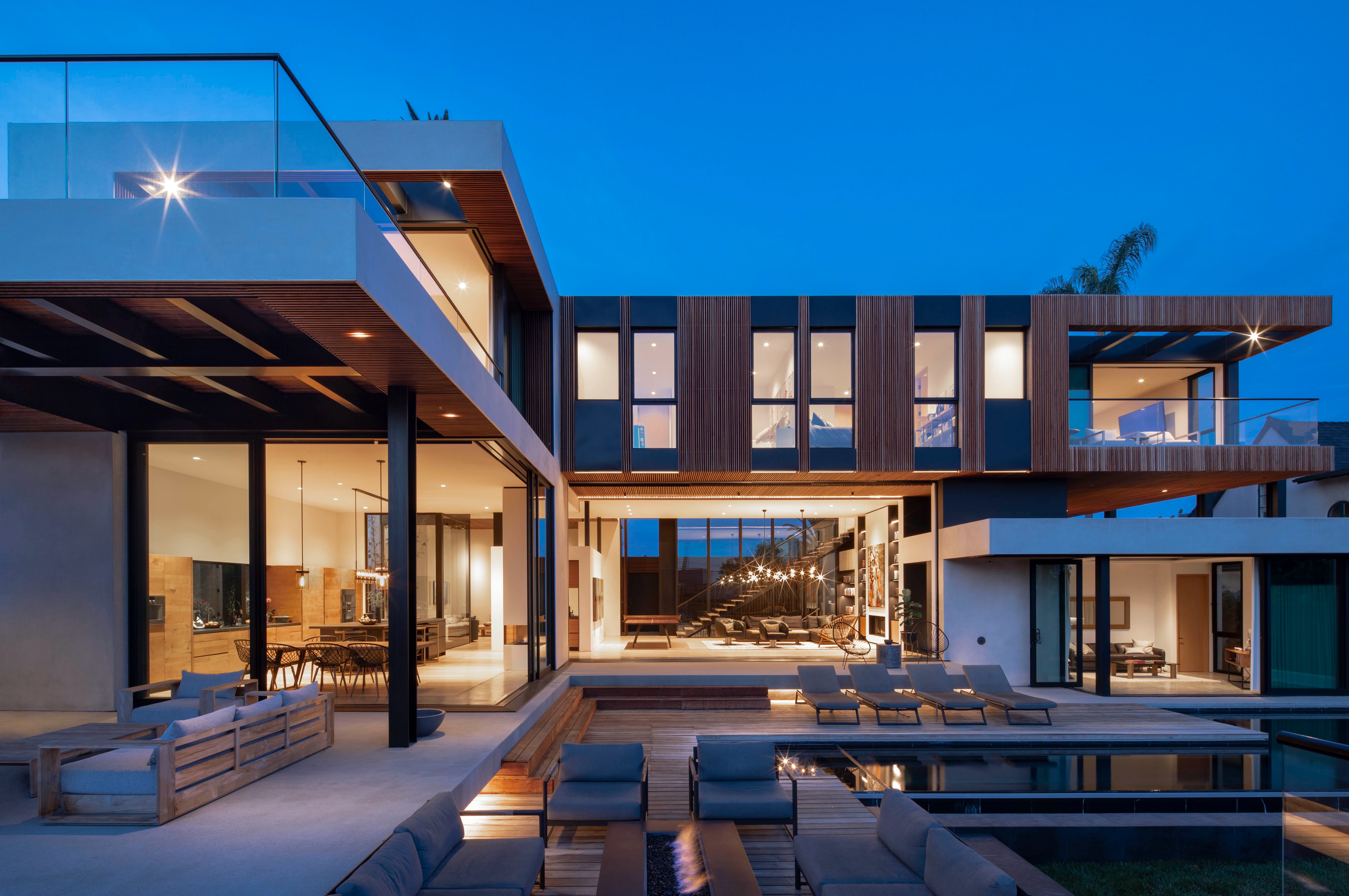 Wasatch Residence at dusk: living spaces open to the pool deck